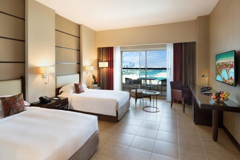 guest room with kitchenette and balcony